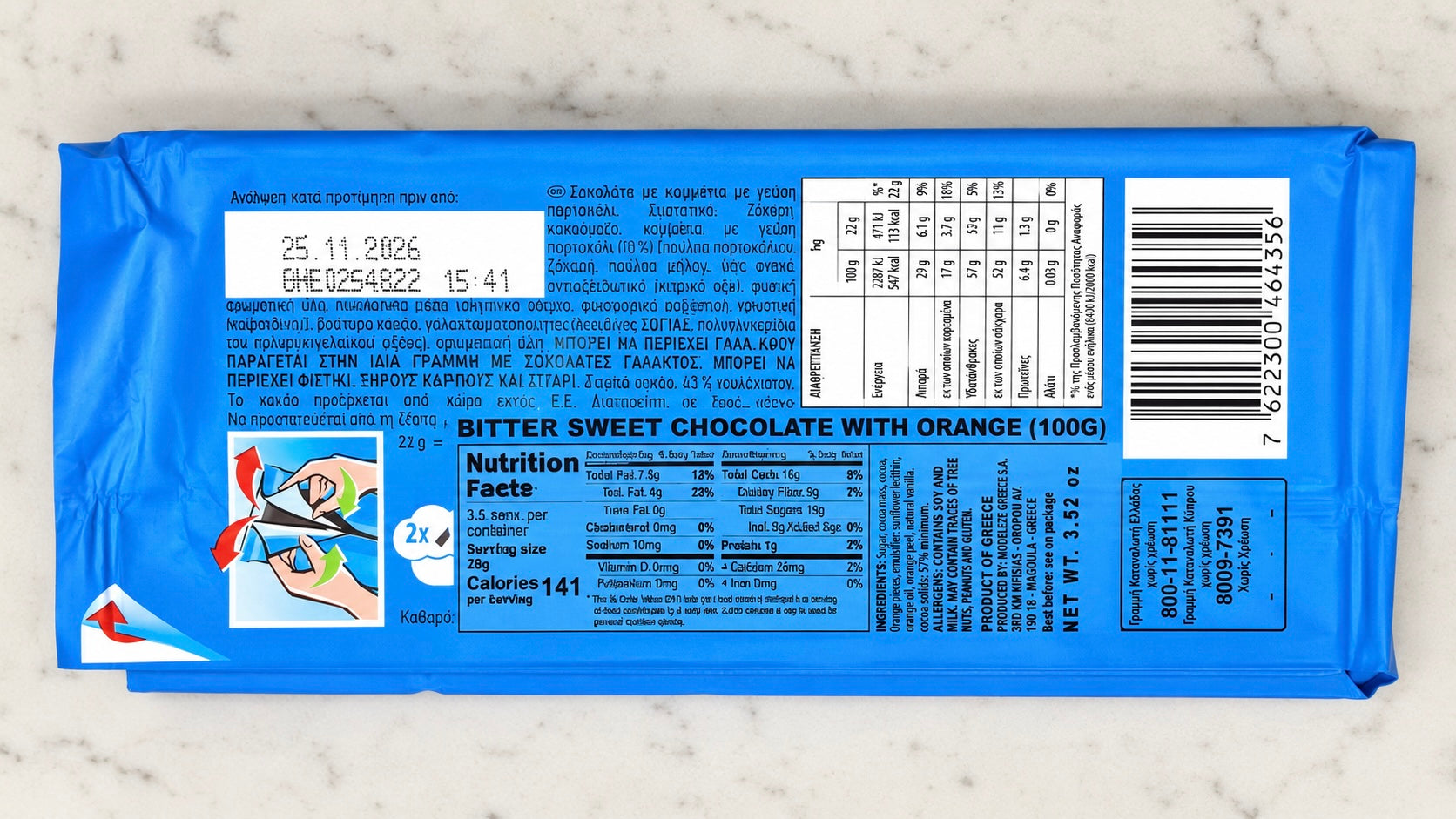 Blue chocolate bar packaging with nutritional information on a marble surface