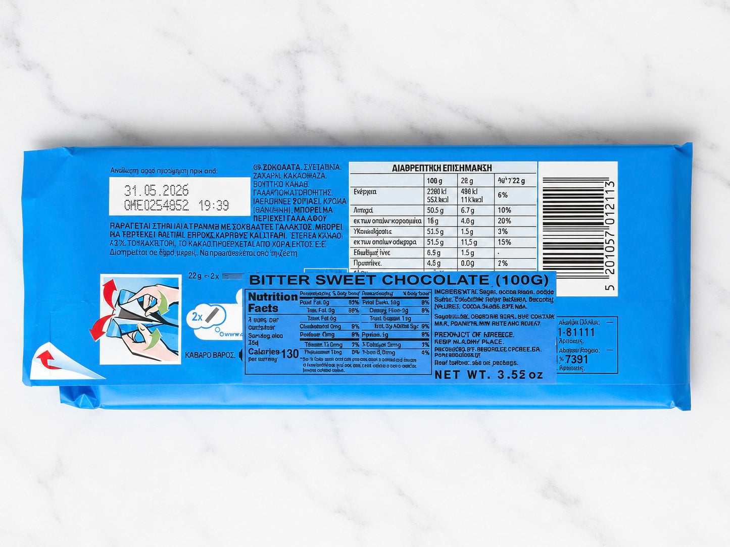 Bitter sweet chocolate bar packaging with nutritional information on a white marble background
