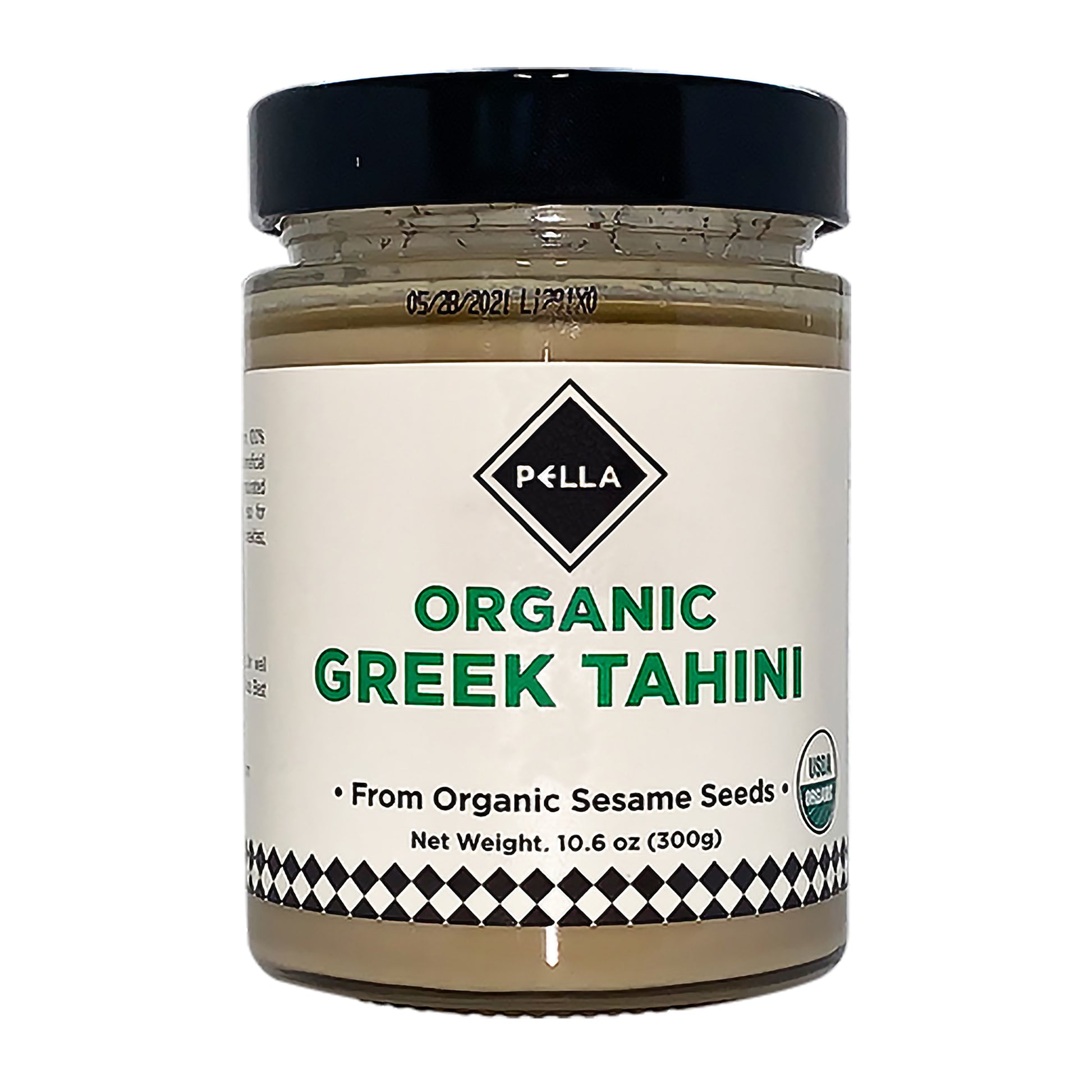 Jar of organic Greek tahini made from sesame seeds with black lid and white label
